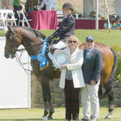 Susie Hutchison and Muscadet de la Saveniere win the $30,000 Blenheim June Classic I Grand Prix on June 7. They are congratulated by Melissa Braunstein, Blenheim EquiSports marketing director, and Bob Drennan, Blenheim EquiSports awards.
