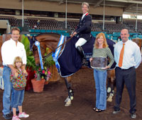 From left: Warren and Lori Wilson of California Horsetrader with their daughter Lily and Show Manager Dale Harvey (right) present awards to Richard Spooner on Apache for winning the $25,000 California Horsetrader Grand Prix.