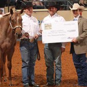 AQHA Senior Director of Publications Jim Bret Campbell (right) presents the Most Valuable Horse check to Jason Martin, Charlie Cole and Vital Signs Are Good.