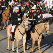 U.S. Marine Corps Color Guard members ride in the 2010 Rose Parade.