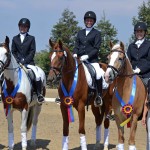 The winning Training Level Team of WR Dressage celebrates its win at the CDS Junior Young Rider Championships, Northern Region, including (from left) manager Michele Vaughn, Haley Fava, Kendra Mitchell, Arianna Barzman-Grennan, and judge Joan Williams.