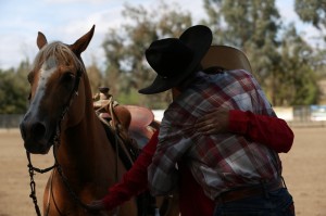 Aaron Brookshire and his fiancee Allyson Tapie embrace after she accepted his proposal in front of the judge's stand at the Southern California Reined Cow Horse Association Shootout on Oct. 16.