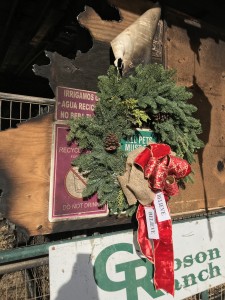 A wreath brightens the bleakness of a gutted stall.